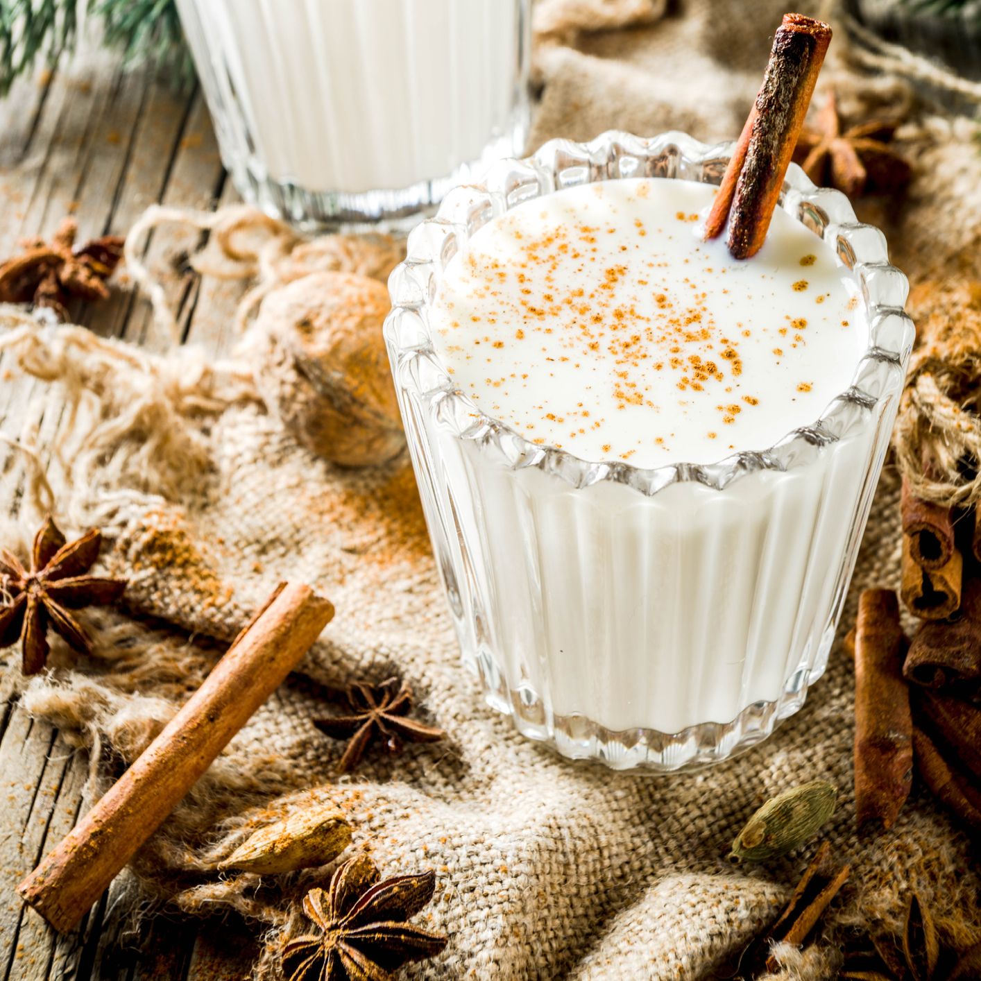 Coquito in glass with cinnamon stick Coquito in glass with cinnamon stick
